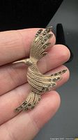 Front view of sterling silver hummingbird brooch with marcasite stones