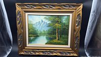 Frontal view of framed landscape oil painting