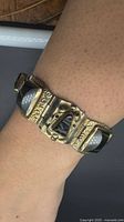 Bracelet on wrist showing panel design and stones
