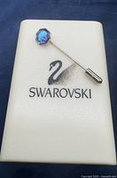 Pin on Swarovski case showing overall design and included case