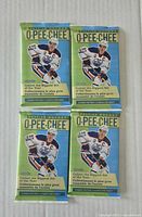 Front view of four sealed O-Pee-Chee NHL card packs