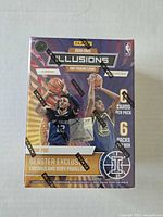 Front of sealed 2020-21 Panini Illusions NBA blaster box highlighting Emerald and Ruby parallels