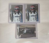 Fronts of three George Russell rookie cards in top loaders