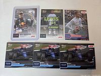 Front view of six Topps NOW F1 cards: Verstappen, Hamilton, Schumacher, three De Vries