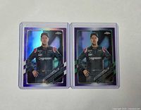 Front view of both Vettel 2021 Topps Chrome purple and purple-green refractor cards in top loaders