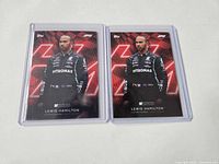 Front view of two Lewis Hamilton Lights Out cards in sleeves