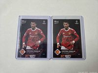 Front view of both Cristiano Ronaldo cards in plastic sleeves