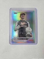 Front of 2022 Topps Chrome Esteban Ocon variation card in sleeve and top loader