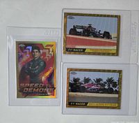 Front view of all three Topps Chrome F1 gold /50 insert cards in holders