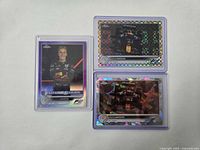 Front view of all three Liam Lawson serial-numbered Topps Chrome cards in top-loaders