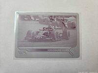 Front of magenta printing plate card showing racing image and Felipe Drugovich name