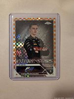 Front of 2023 Topps Chrome Theo Pourchaire card with orange checker border in protective holder