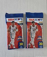 Front view of two sealed 2020-21 Panini NBA Hoops value packs