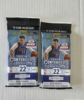 Front view showing two sealed Panini Contenders 22-card packs with Luka Dončić cover