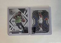 Front view of both Anthony Edwards rookie cards in sleeves