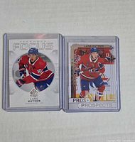 Front of both Lane Hutson rookie cards in holders