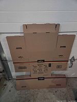 Front view of flattened Offix cardboard box showing logo, handles, fold pattern