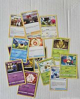 overview of approximately 15 Pokémon cards spread out
