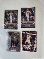Fronts of four NBA trading cards in sleeves