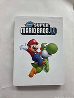 Front view of white steelbook with Mario and Yoshi artwork