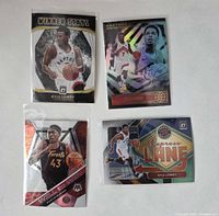 Front view of four sleeved Toronto Raptors cards