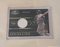 Front of 2003 Donruss Classics Dress Code Vernon Wells jersey card showing player image and jersey swatch