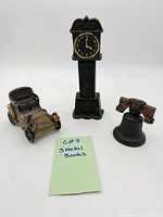 Group shot of the three cast metal banks: automobile, grandfather clock, Liberty Bell