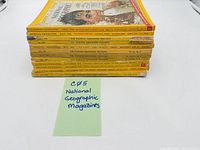Stack of twelve National Geographic magazines side view