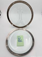 Both round platters displayed on stands showing size and appearance