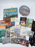 Group shot of all items including magazine, maps, brochures, record, postcards, tie