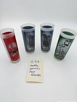 Group shot of four Seattle World’s Fair glasses front graphics visible