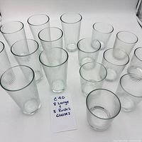Overhead of all 16 ribbed clear glasses arranged