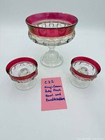 Pedestal compote bowl and two candleholders displayed together