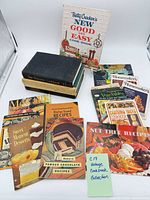 Group shot showing all 17 cookbooks and pamphlets