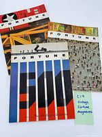 Three Fortune magazines laid out showing covers