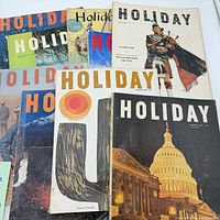 Group shot of nine Holiday magazines showing various covers