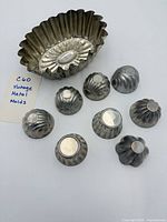 Overview of large and eight small metal molds