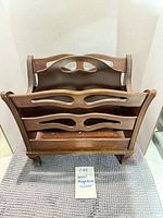 Front view of wooden magazine holder showing overall design and condition