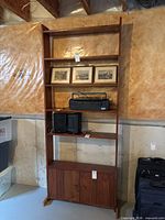 Full front view of bookshelf showing shelves and cabinet