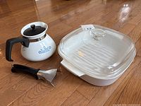 Overall view of casserole with lid, coffee carafe, and detachable handle