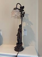 Full view of figural lamp showing shade and base