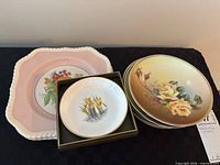 Group view showing floral side plates stack, Johnson Brothers fruit plate, miniature Royal Worcester plate in box