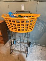 Overall view of metal cart, basket and contents