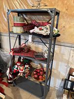 Front view of grey metal 4-shelf unit with contents (not included)