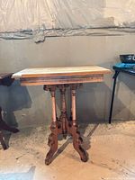 Full view of oak Eastlake side table showing legs and stretcher