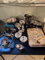 Overview of all silverplate and sterling pieces on table