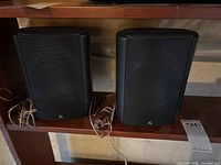 Front view of both black AR speakers showing size and grille