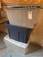 Stack of three plastic totes showing colors and lids