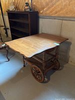 Tea wagon top open displaying drop leaves and wheels