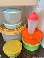 Stack of colorful Tupperware containers showing variety